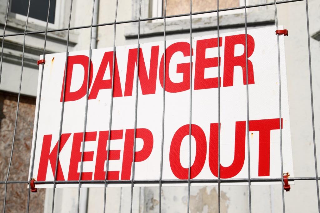 Danger keep out sign on a wire security fence.